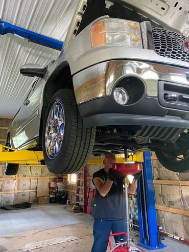 Dewey Beatty servicing a vehicle on the lift at A2Z Services